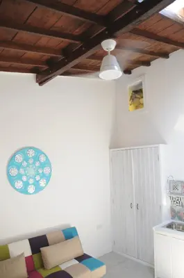 a living room with a couch and a ceiling at The Stable in Limassol