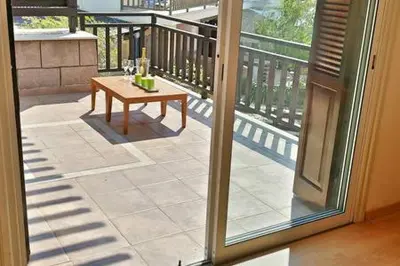 a view of a patio with a table on a balcony at Larnaka Beach House 3 in Larnaka