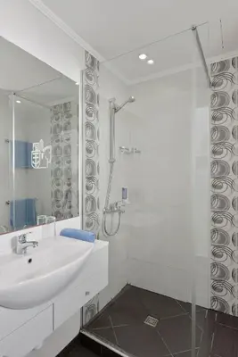 a white bathroom with a sink and a shower at Napa Prince Hotel Apts in Ayia Napa