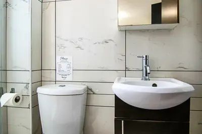 a bathroom with a toilet and a sink at Seaside Luxury Flat Pervolia in Pervolia
