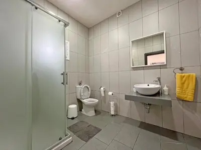 a bathroom with a toilet and a sink at Apollo Rooms by Albert's Apartment in Larnaka