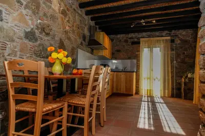 a kitchen with a table and chairs in a room at Farmakas Living in Farmakas