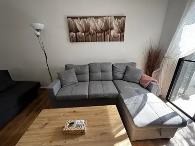 a living room with a gray couch and a table at Theodoros Apt. 408 in Protaras