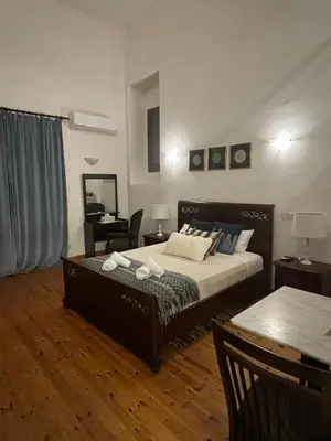 a bedroom with a bed and a table and a chair at Theoxenia in Kalopanayiotis
