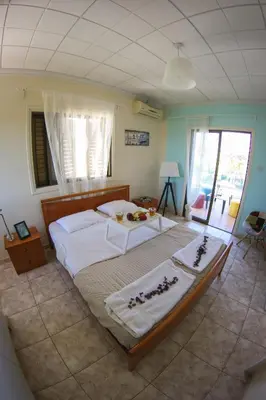 a bedroom with a large bed with white sheets at Villa Alexandra in Ayia Napa