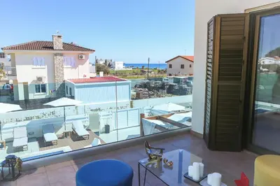 a room with a balcony with a view of the ocean at Villa Alexandra in Ayia Napa