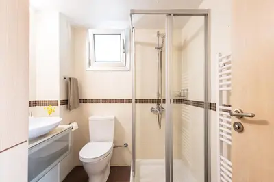a bathroom with a toilet and a glass shower at Villa Chrysta in Ayios Theodhoros