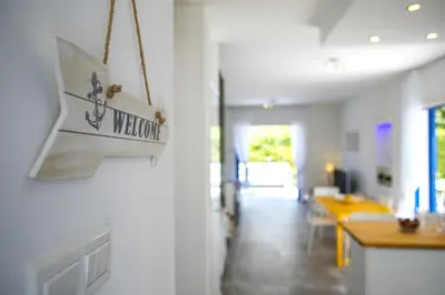 a living room with a sign on the wall at Protaras Villa Loulla in Protaras