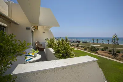 a balcony of a house with a view of the ocean at Larnaca Sunshore Beachfront Suite in Voroklini