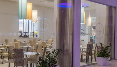 a restaurant with tables and chairs in a room at Stamatia Hotel in Ayia Napa
