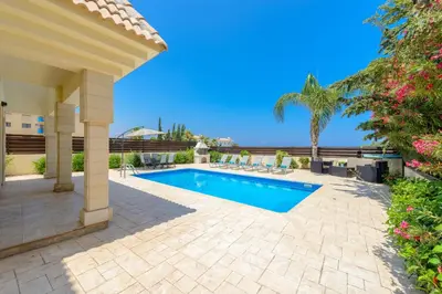a patio with a swimming pool and a house at Villa Irina in Paralimni
