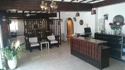 a lobby with a reception desk and chairs at Lordos Hotel Apts Limassol in Limassol