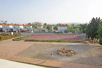a tennis court with a bunch of rocks on a court at Neraida - 2Bed Apart walk to Kalamies Beach in Protaras