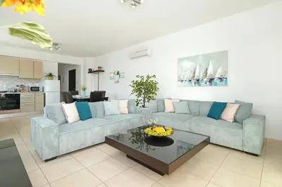 a living room with two couches and a coffee table at Neraida - 2Bed Apart walk to Kalamies Beach in Protaras