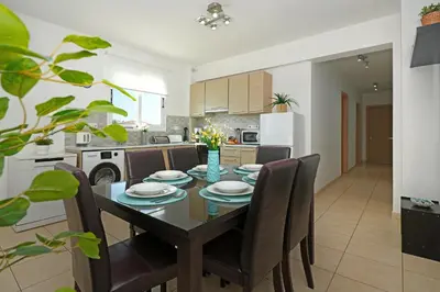 a kitchen and dining room with a table and chairs at Neraida - 2Bed Apart walk to Kalamies Beach in Protaras