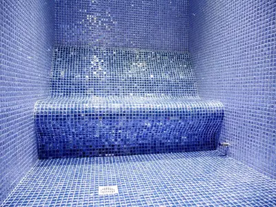 a blue tiled shower with a blue tiled stairs at Amethyst Napa Hotel & Spa in Ayia Napa