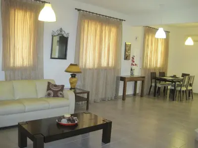 a living room with a couch and a table at Polyxenia Isaak Villa Heaven Pernera in Protaras