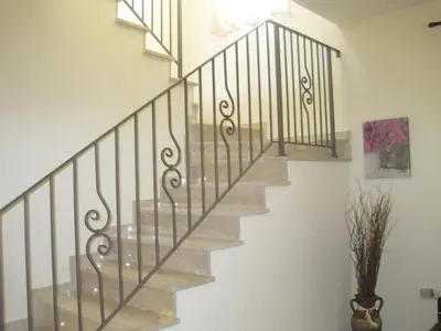 a staircase in a home with wrought iron railings at Polyxenia Isaak Villa Heaven Pernera in Protaras
