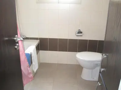 a bathroom with a toilet and a tub and a sink at Polyxenia Isaak Villa Heaven Pernera in Protaras