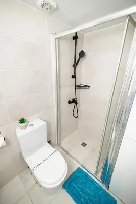 a bathroom with a toilet and a shower at Lazuli Beachfront Sea View Ap144 in Larnaka