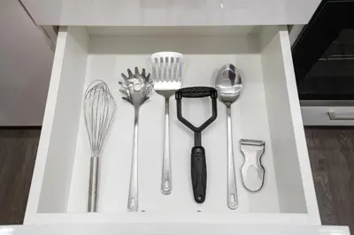 a kitchen utensils are arranged in a white drawer at Lazuli Beachfront Sea View Ap144 in Larnaka