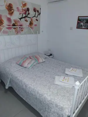 a bedroom with a bed with two towels on it at Studio Apartment Near the Beach in Larnaka