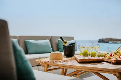 a table with wine glasses and food on it at Nissi Beach Resort in Ayia Napa
