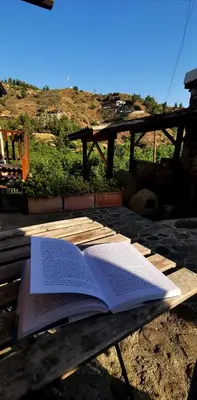 an open book sitting on a wooden table at Maritsa Lodge in Kakopetria