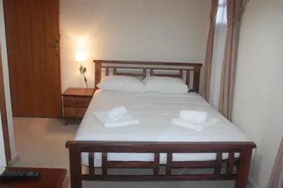 a bedroom with a bed with two white pillows at Maritsa Lodge in Kakopetria