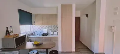 a small kitchen with a table and a counter top at Ha.De.Co. Holiday Apts in Ayia Napa
