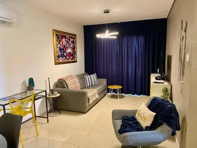 a living room with a couch and a table at Fat Cow Apartment 101 in Larnaka