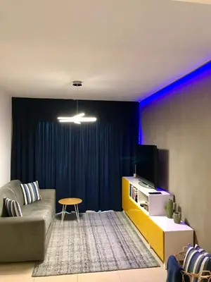 a living room with a couch and a tv at Fat Cow Apartment 101 in Larnaka