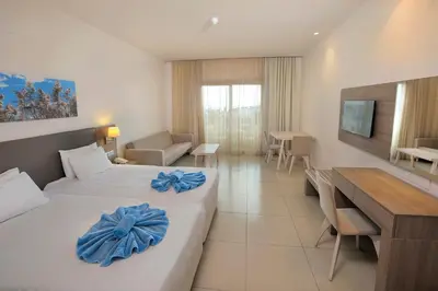 a hotel room with two beds with blue bows on them at Euronapa Hotel Apartments in Ayia Napa