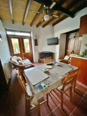 a kitchen and living room with a table and chairs at Arhontiko Askas Mansion in Askas