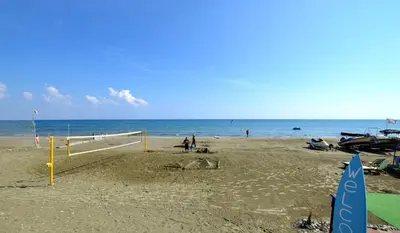 a beach with a volley ball net and the ocean at Mackenzie Blu Beach Studio in Larnaka