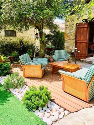 three chairs and a table on a wooden deck at Listed Villa in Laneia in Lania