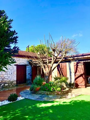 a house with a tree in the middle of a yard at Listed Villa in Laneia in Lania