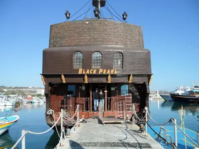 a black pearl restaurant on a boat in the water at SUNSHINE APTS, TWO BEDROOM , FREE INTERNET, No 3 in Ayia Napa