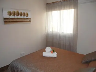 a bedroom with a bed with a towel on it at SUNSHINE APTS, TWO BEDROOM , FREE INTERNET, No 3 in Ayia Napa