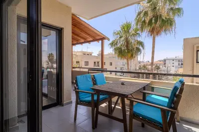 a patio with a table and chairs on a balcony at Lazaros Suite Downtown in Larnaka