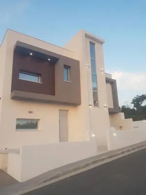 a large white house with a large window at Villa Chrystalleni in Protaras