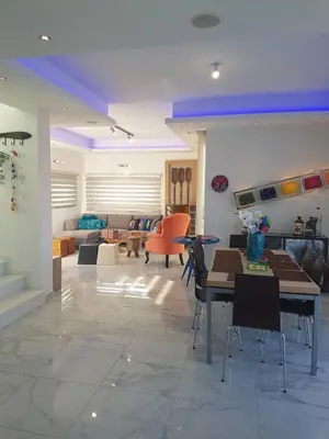 a living room with a table and chairs and a couch at Villa Chrystalleni in Protaras