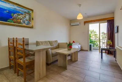 a living room with a table and a couch at Antonis G. Hotel Apartments in Voroklini