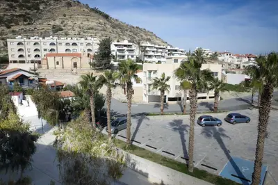 a view of a city with palm trees and buildings at Antonis G. Hotel Apartments in Voroklini