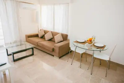 a living room with a couch and a table at Vega Apartments in Limassol