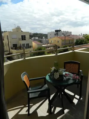 a table and chairs on a balcony with a view at M. Moniatis Hotel in Limassol