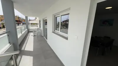 a hallway of a building with windows and a table at Christabelle Hotel Apartments in Ayia Napa