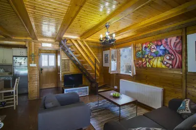 a living room with two couches and a table at Ricky Chalet Near Troodos in Spilia