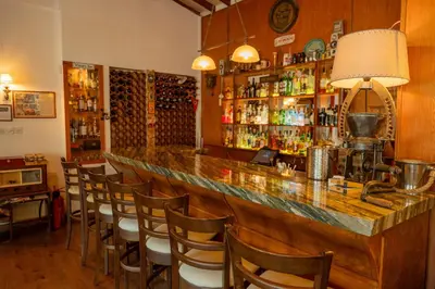 a bar with a bunch of chairs around it at New Helvetia Historic Hotel in Platres