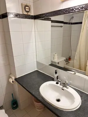 a bathroom with a sink and a mirror at San Remo Hotel in Larnaka